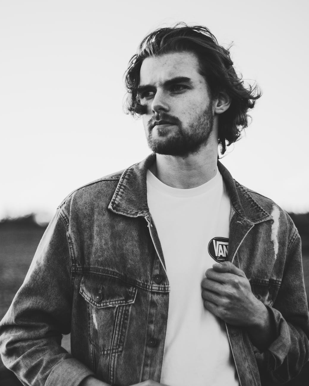 grayscale photo of man wearing denim jacket