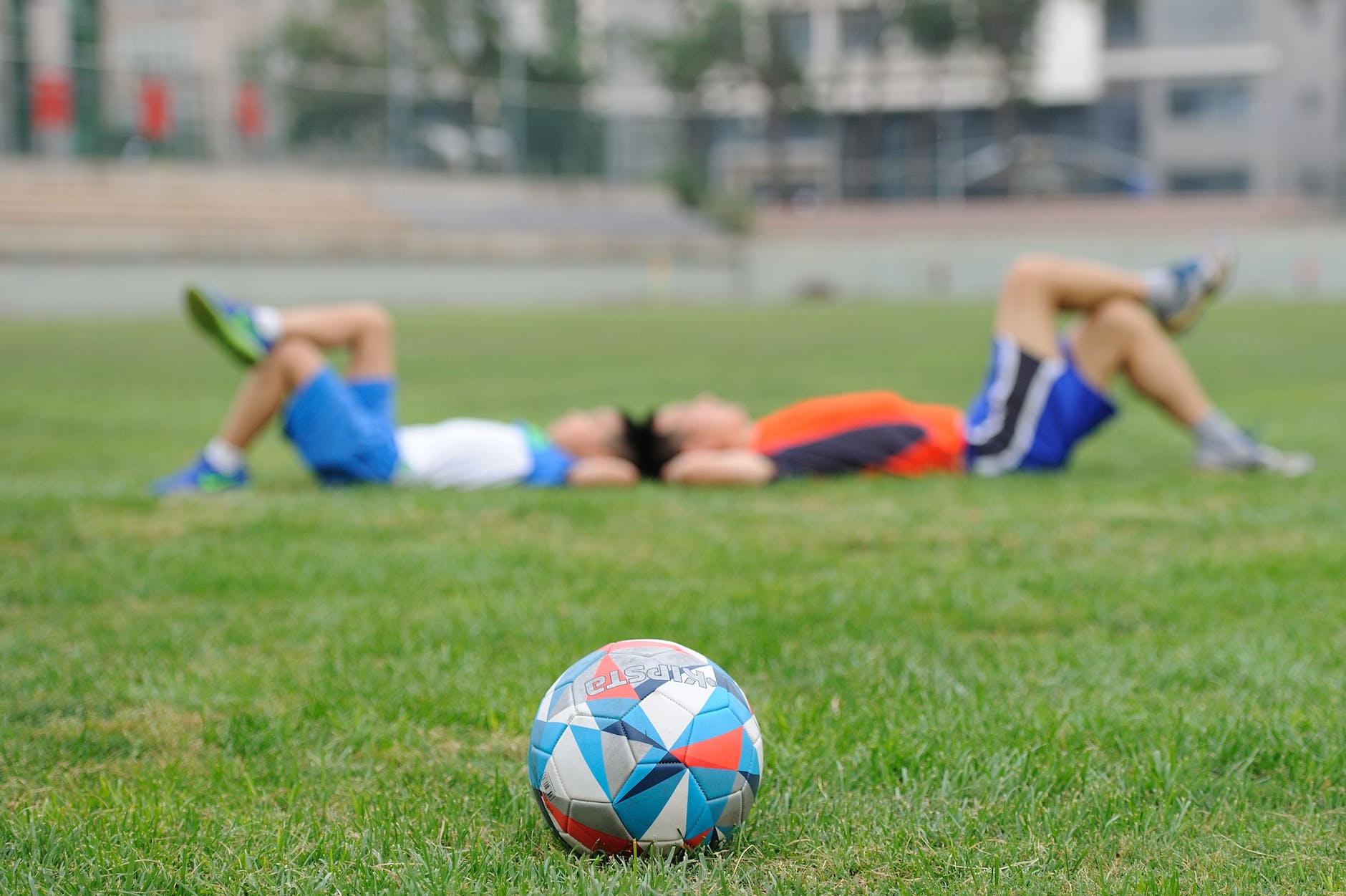 woman playing soccer ball on grass