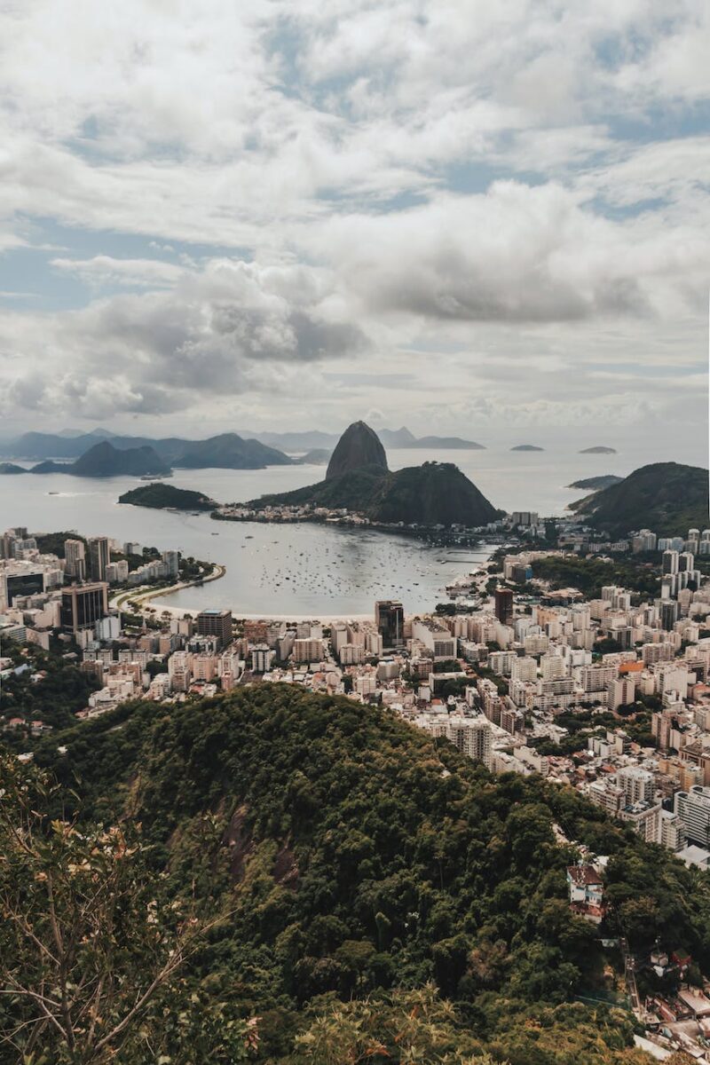 city near body of water under cloudy sky