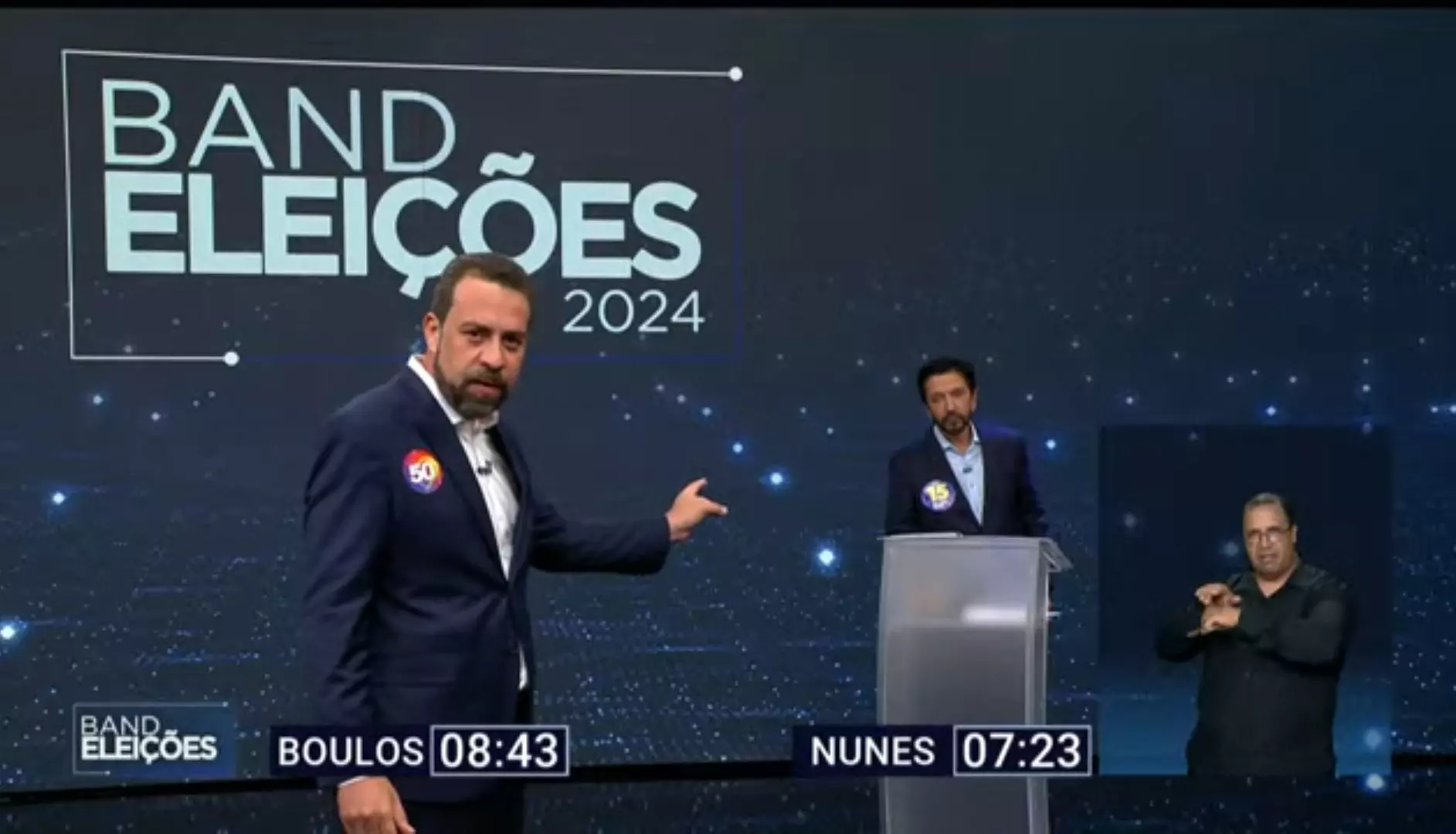 Guilherme Boulos e Ricardo Nunes no debate da Band