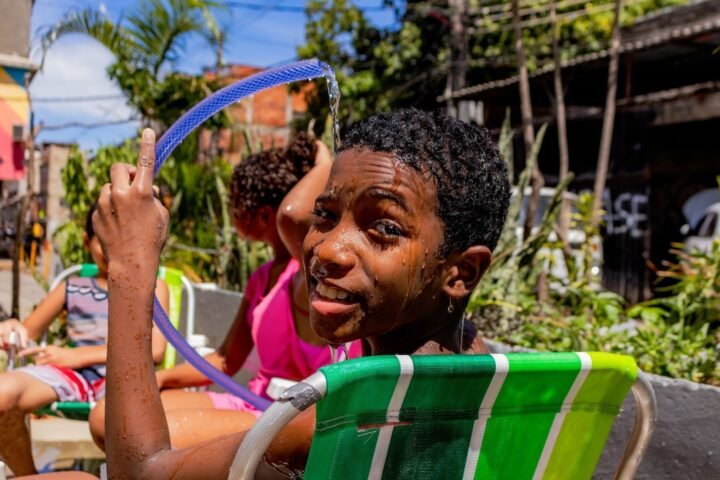 Banho de mangueira no Bela Verão 2025 no Galpão Bela Maré. Fotografia: Thaís Valêncio (Observatório de Favelas)